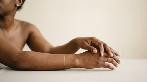 arms and hands resting on a table